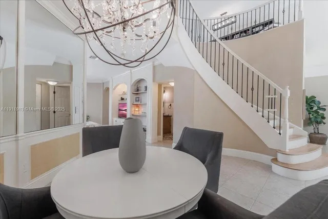 a living room with furniture and a dining table with kitchen view