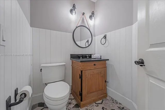 a kitchen with kitchen island granite countertop a sink window and cabinets