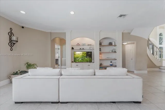 a kitchen with white cabinets and sink