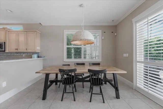 a living room with furniture and a kitchen area