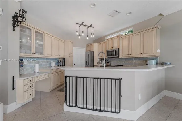 a view of a dining room with furniture a chandelier and wooden floor