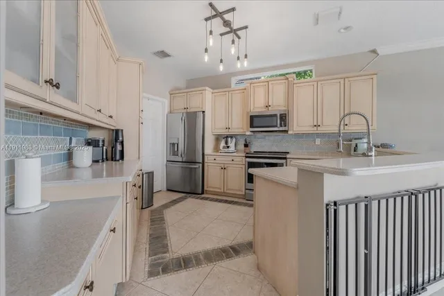 a view of a hallway with wooden floor and a bathroom