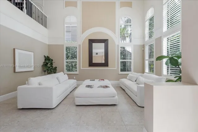 a living room with furniture and large windows