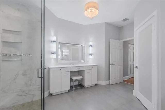 a bedroom with a bed and a view of bathroom