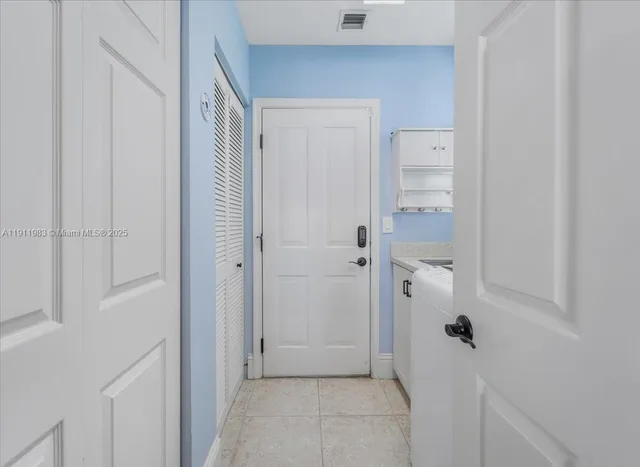 a view of a house with backyard and a tree
