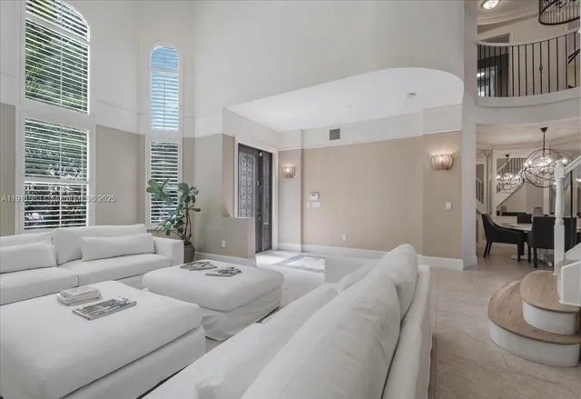 a view of a dining room with furniture a chandelier and wooden floor
