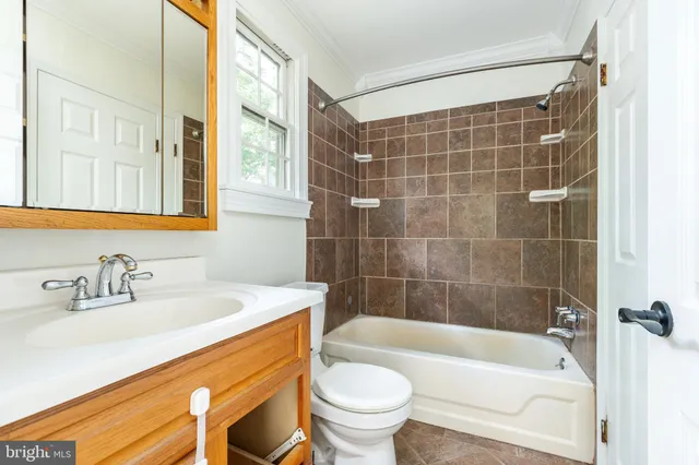 a bathroom with a sink mirror toilet and bathtub