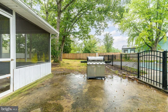 a view of a patio with a table chairs and a backyard