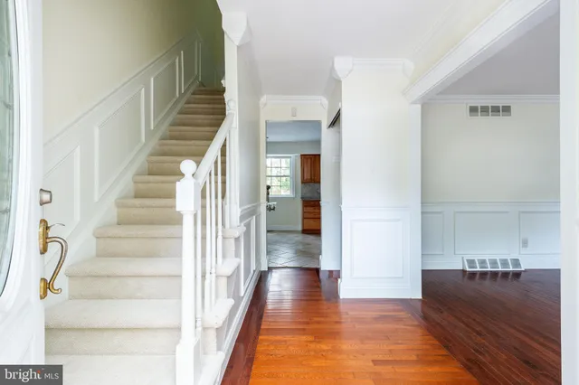 a view of entryway and hall with wooden floor