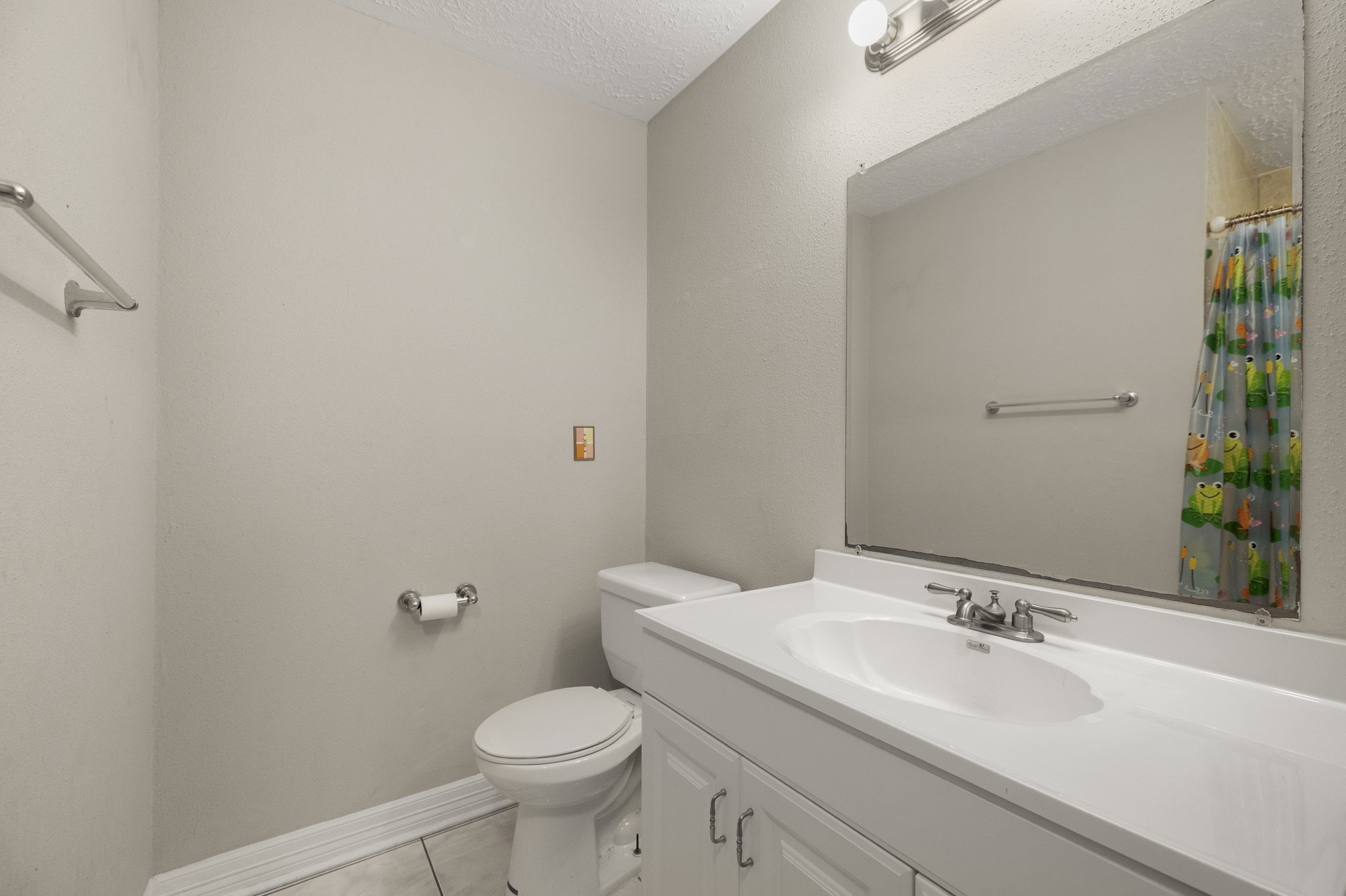 23826 Lestergate Drive Spring, TX 77373 - Photo 23 of 45 Stepping across the hall into the second bath, the vanity offers useful counter space with a mirror above, while the toilet sits just beyond. In the mirror’s reflection, you can also see the tub/shower.