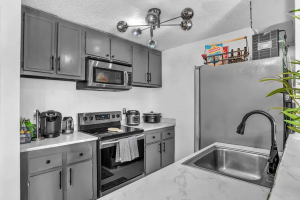 a kitchen with a sink stove and cabinets
