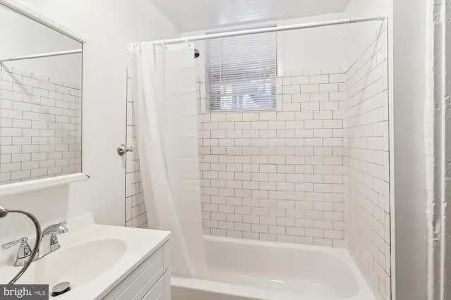 a bathroom with a shower and a sink