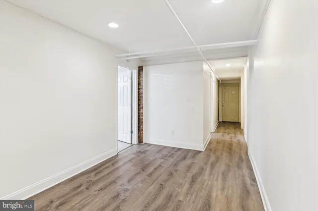 a view of hallway with wooden floor
