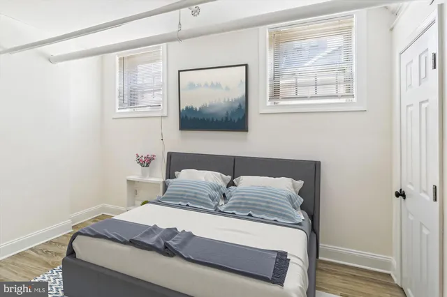 a bedroom with a bed and wooden floor