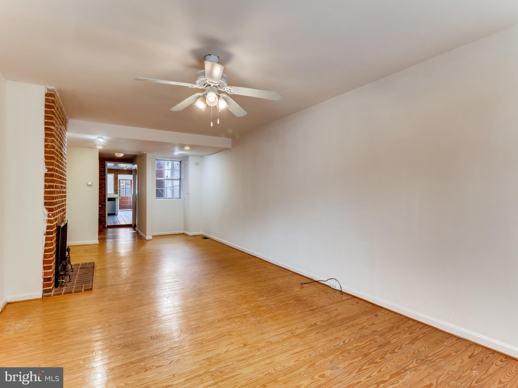 1434 Riverside Avenue Baltimore, MD 21230 - Photo 3 of 28 wooden floor in an empty room with a window