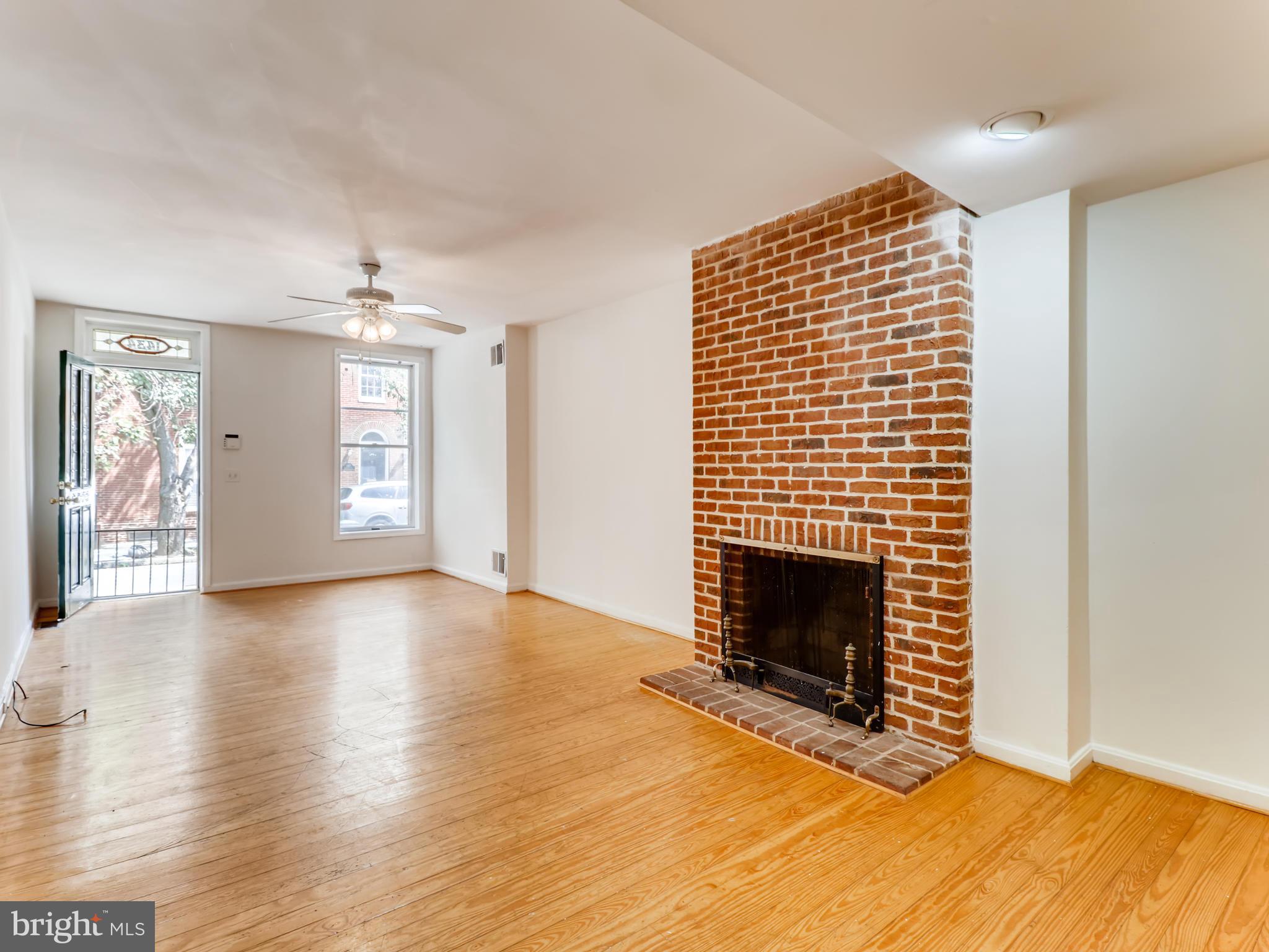1434 Riverside Avenue Baltimore, MD 21230 - Photo 4 of 28 a view of an empty room with window and fire place