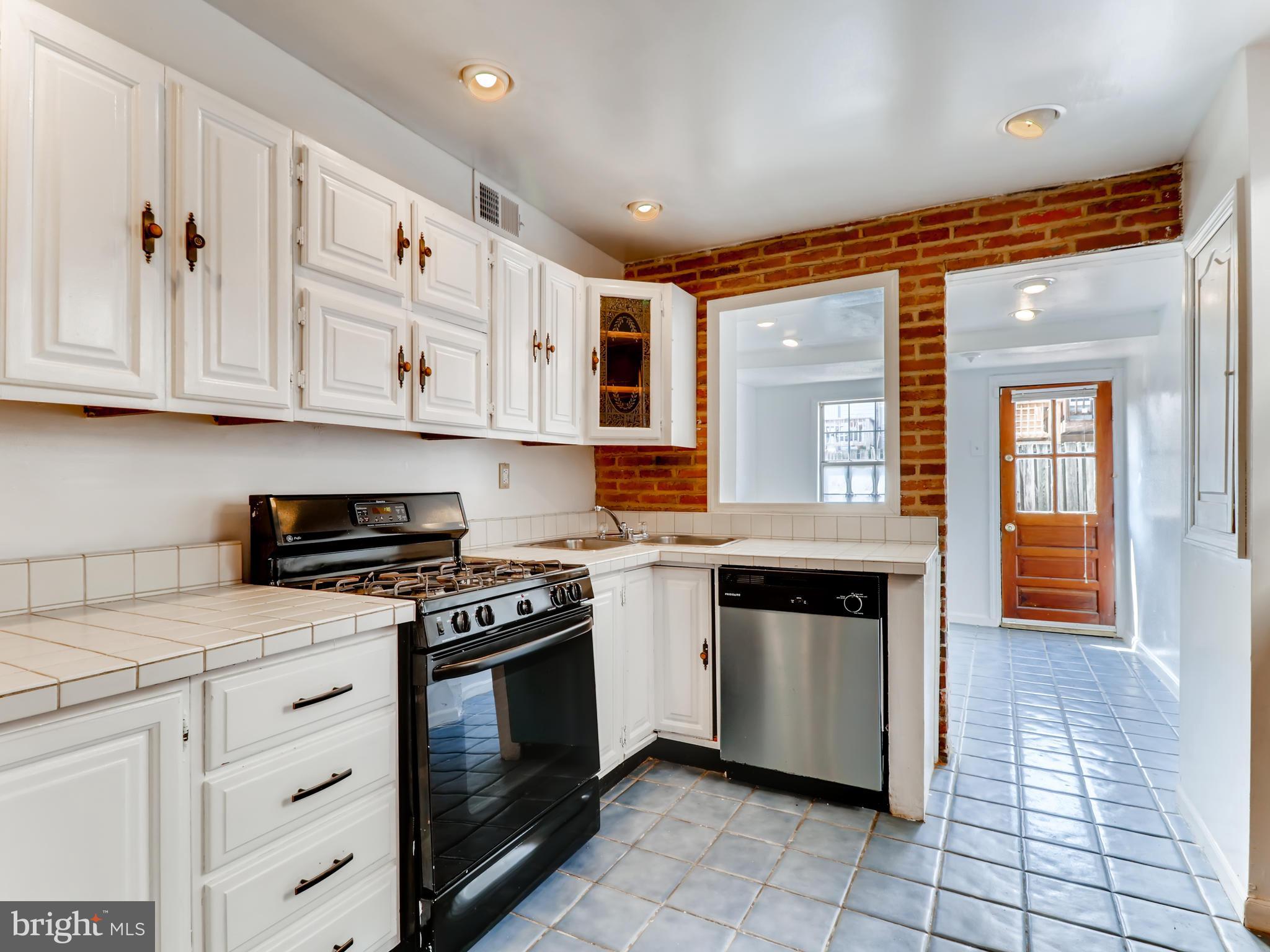 1434 Riverside Avenue Baltimore, MD 21230 - Photo 8 of 28 a kitchen with stainless steel appliances granite countertop a stove and a sink