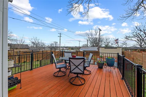 a view of a wooden deck front of house