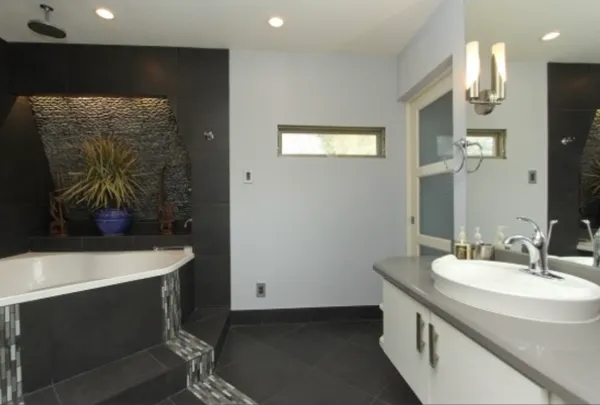 a bathroom with a double vanity sink and a mirror