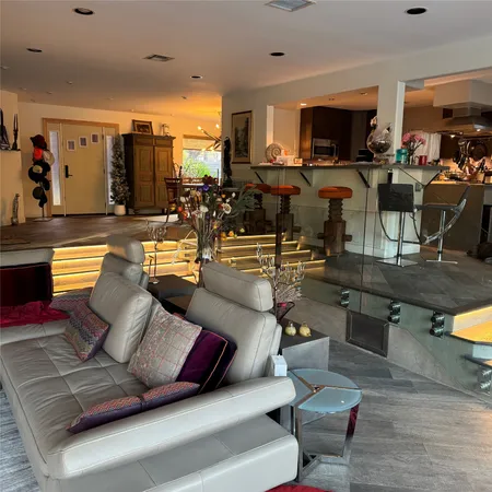 a living room with furniture a fireplace and a large window