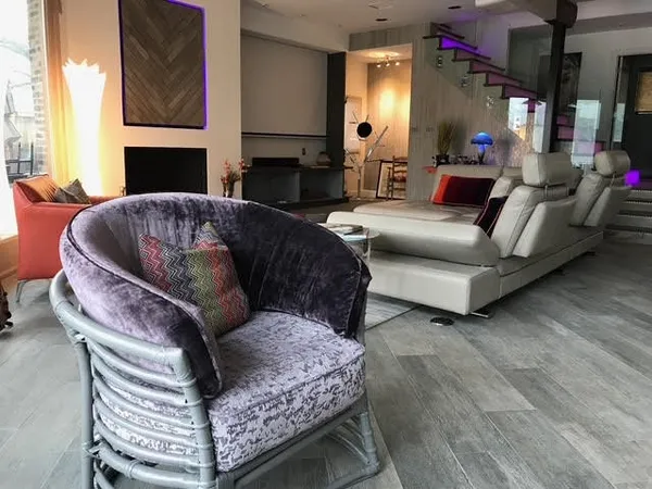 a living room with furniture a rug and a fireplace