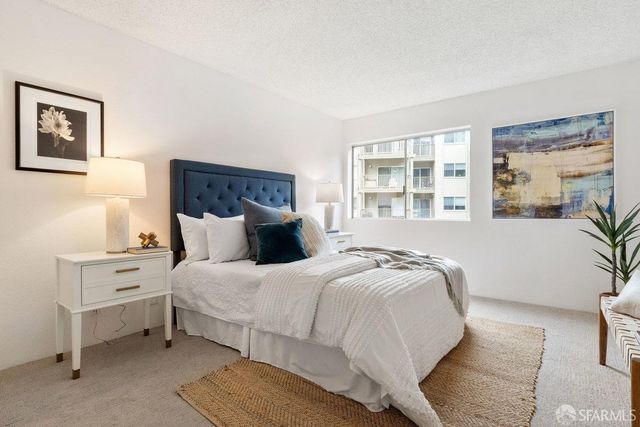 a spacious bedroom with a bed and window