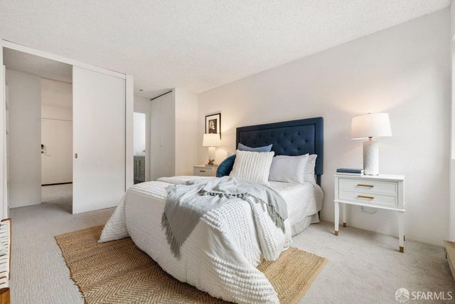 a bedroom with a bed and lamps