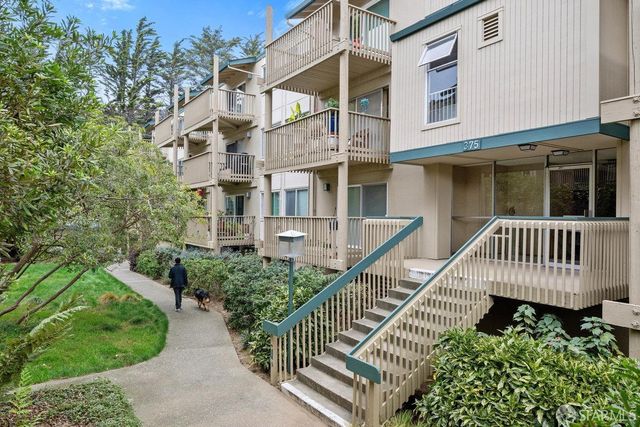 an outdoor view of a house with swimming pool