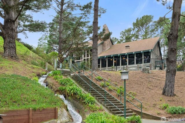 a front view of a house with a yard table and chairs