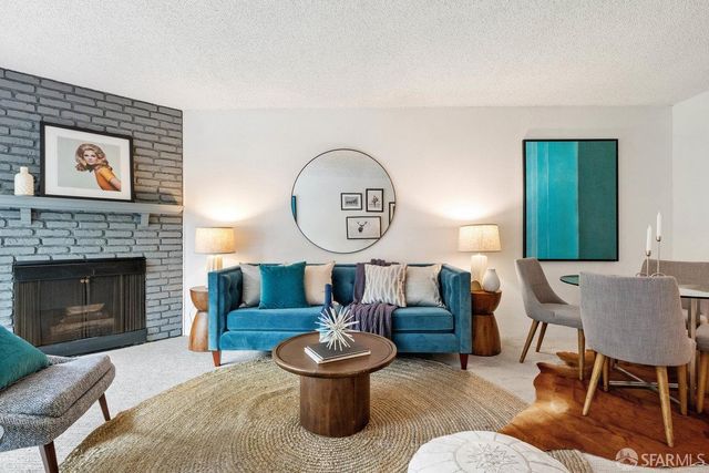 a living room with furniture and a fireplace