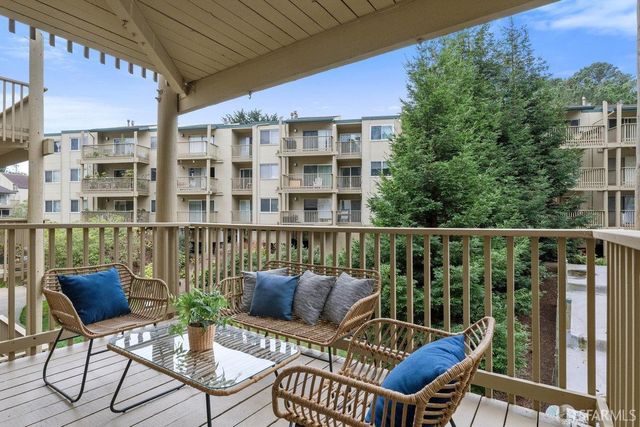 a view of a balcony with chairs