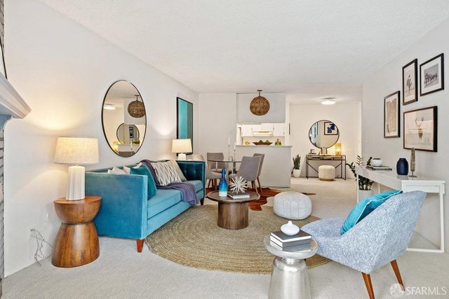 a living room with furniture a large window and a clock