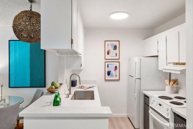 a bathroom with a sink and a refrigerator