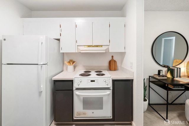 a kitchen with a stove a refrigerator and a stove