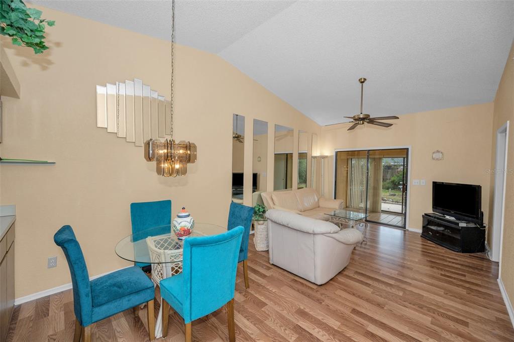 11511 113th Street, Unit 35E Largo, FL 33778 - Photo 13 of 77 a living room with furniture a flat screen tv and wooden floor