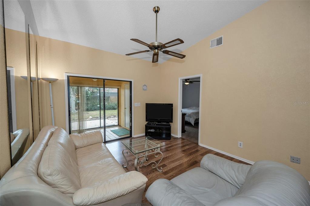 11511 113th Street, Unit 35E Largo, FL 33778 - Photo 16 of 77 a living room with furniture and a flat screen tv