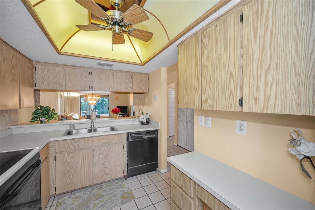 11511 113th Street, Unit 35E Largo, FL 33778 - Photo 18 of 77 a kitchen with a sink cabinets and window