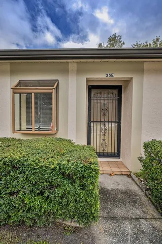 a living room with furniture and a view of kitchen