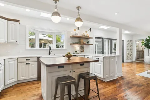 a kitchen with a sink cabinets and window