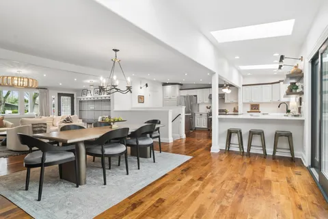 a view of a dining room with furniture and chandelier