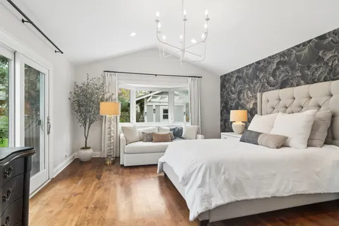 a bedroom with a large bed and a large window