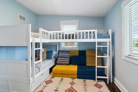 a bedroom with a bed and a book shelf