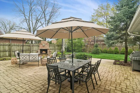 an outdoor space with patio and white umbrellas