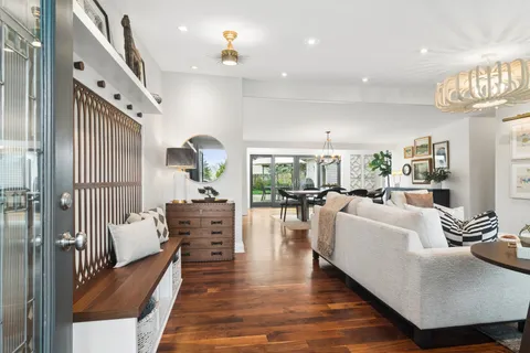 a living room with furniture and a chandelier