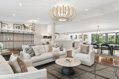 a living room with furniture and a chandelier