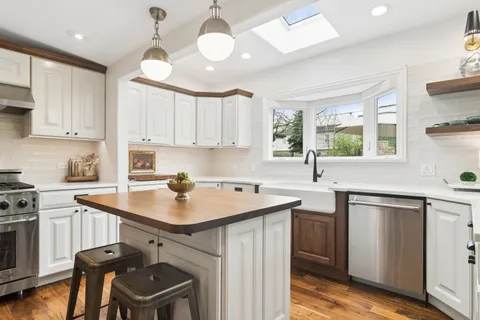 a kitchen with a sink stove and cabinets