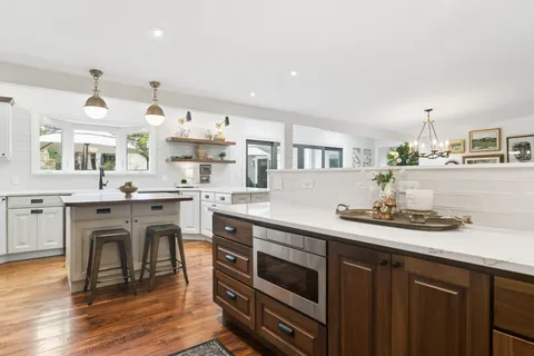 a kitchen with a sink cabinets and wooden floor