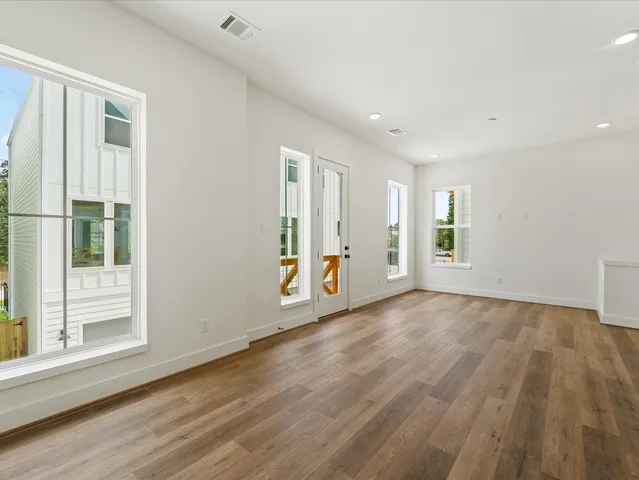 a kitchen with stainless steel appliances granite countertop a sink a oven and wooden floors