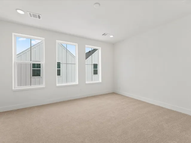 a view of a kitchen with kitchen island a sink wooden floor and a refrigerator