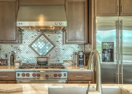 a kitchen with sink stove and refrigerator